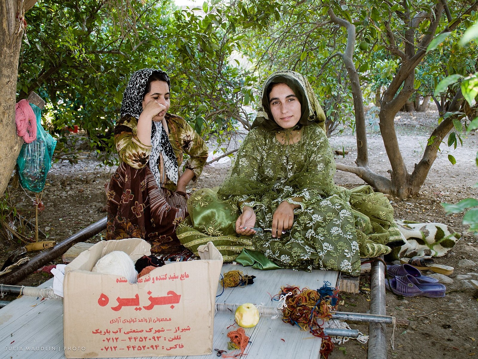 Qashqai nomad sisters weave a carpet on a floor loom near Firuzabad, Iran (14288453190).jpg