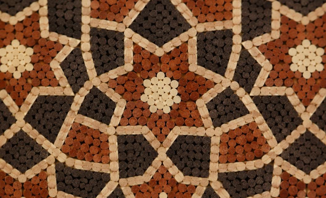 Macro detail of khatam inlay forming a repeating star motif